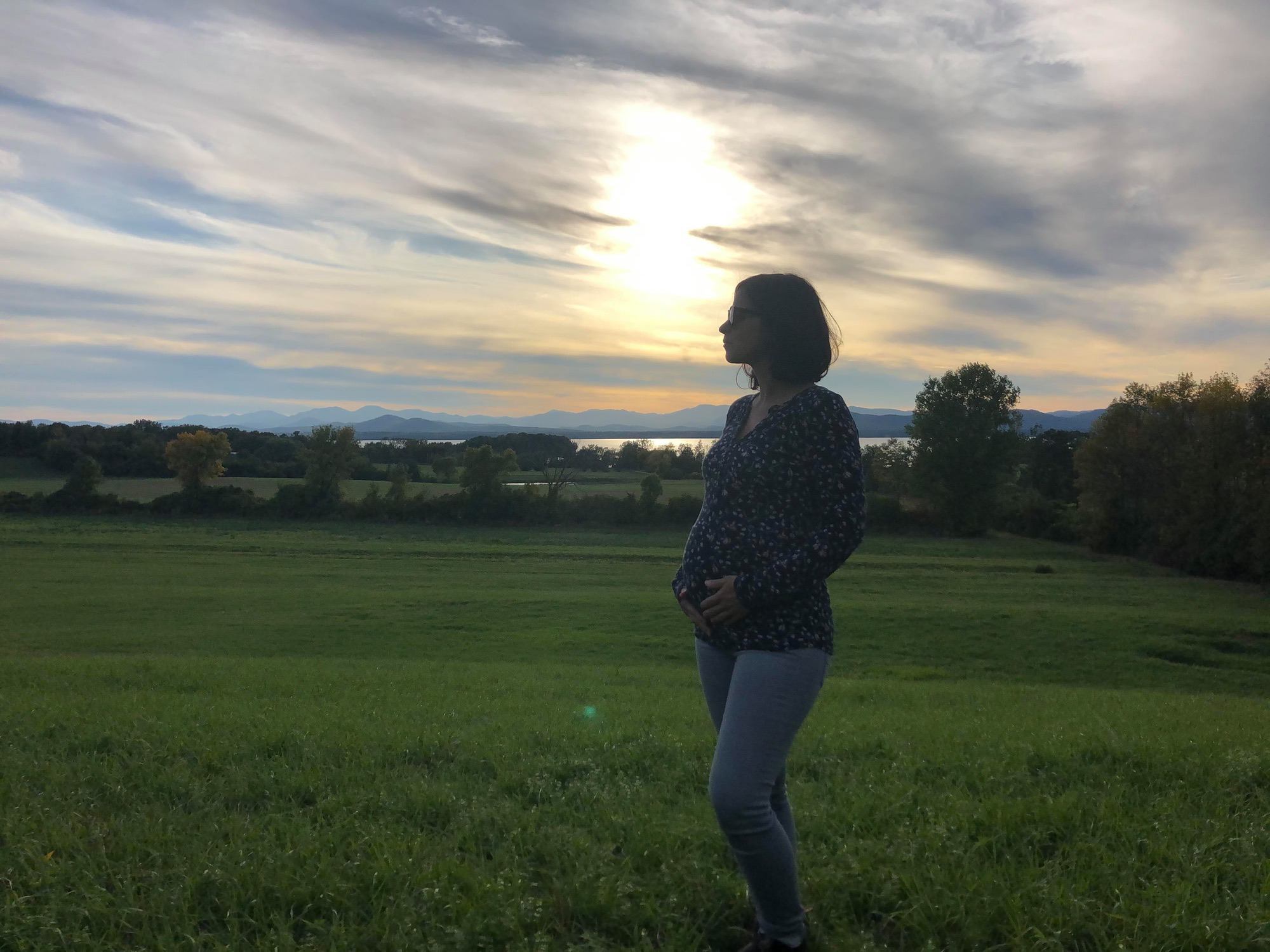Vermont Surrogacy Network Surrogate standing outside at dusk in Vermont